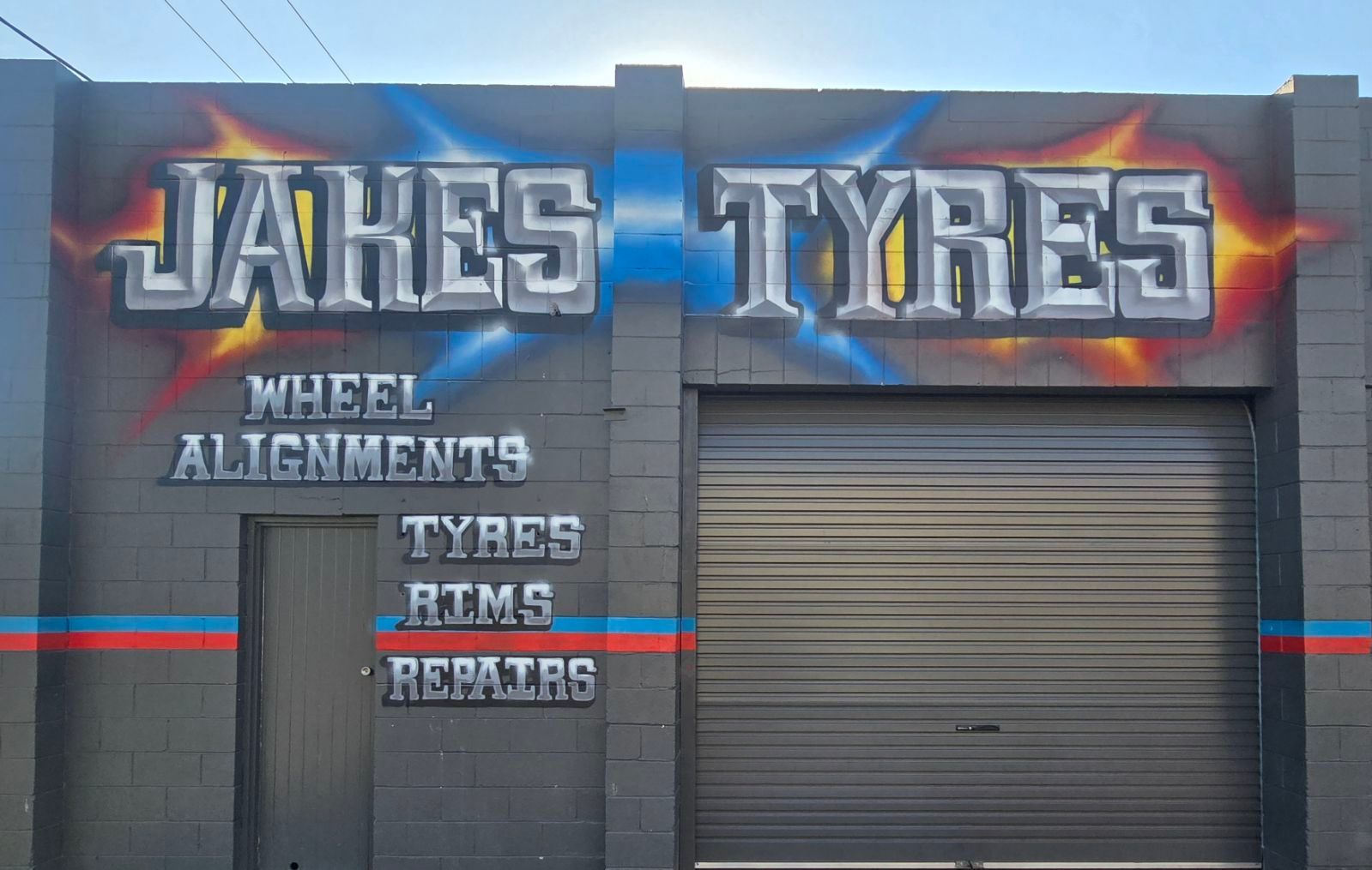 A Shop Exterior with Graffiti Style Signage — Jakes Tyres in South Murwillumbah, NSW