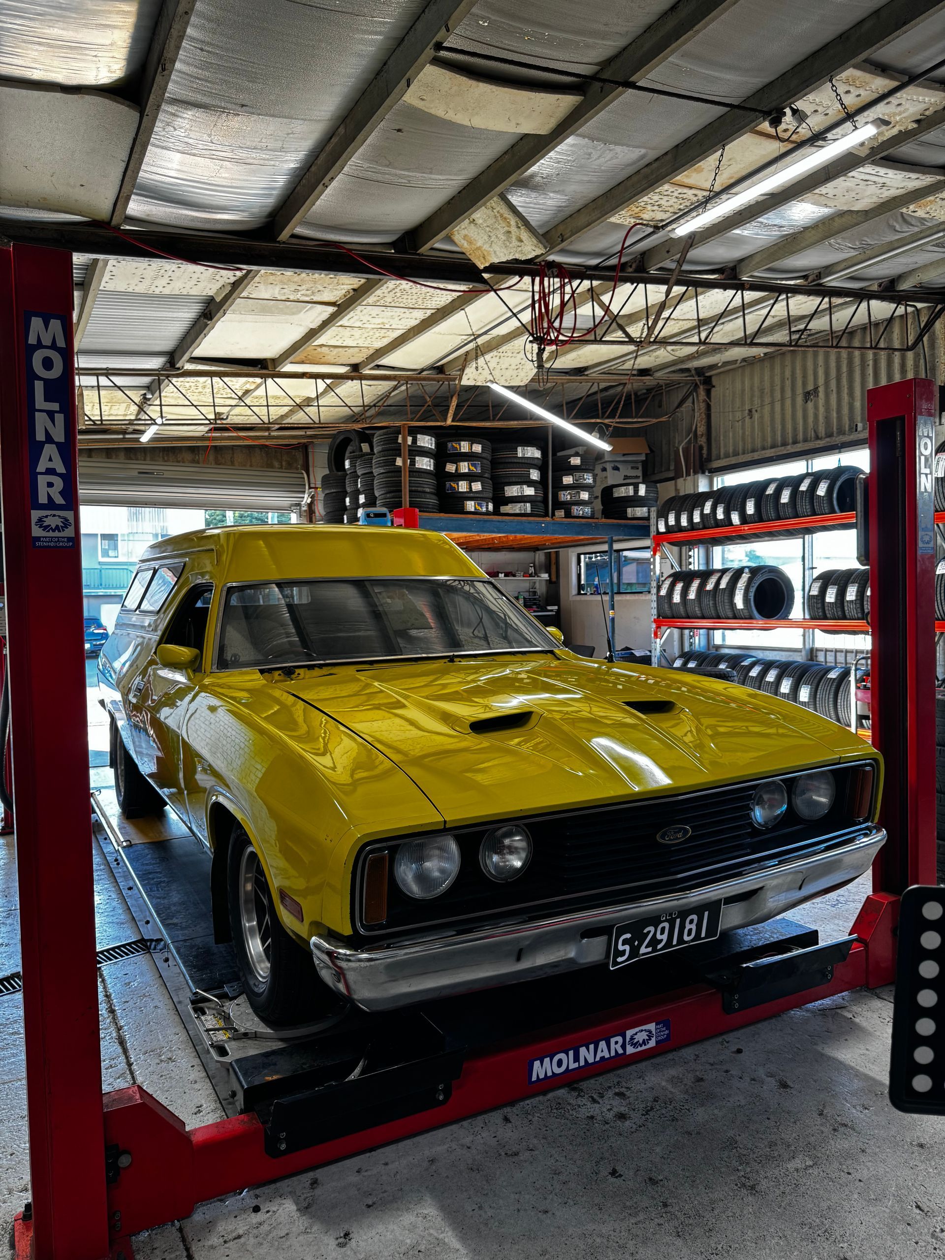 A Car on A Red Molnar Lift in A Garage — Jakes Tyres in South Murwillumbah, NSW
