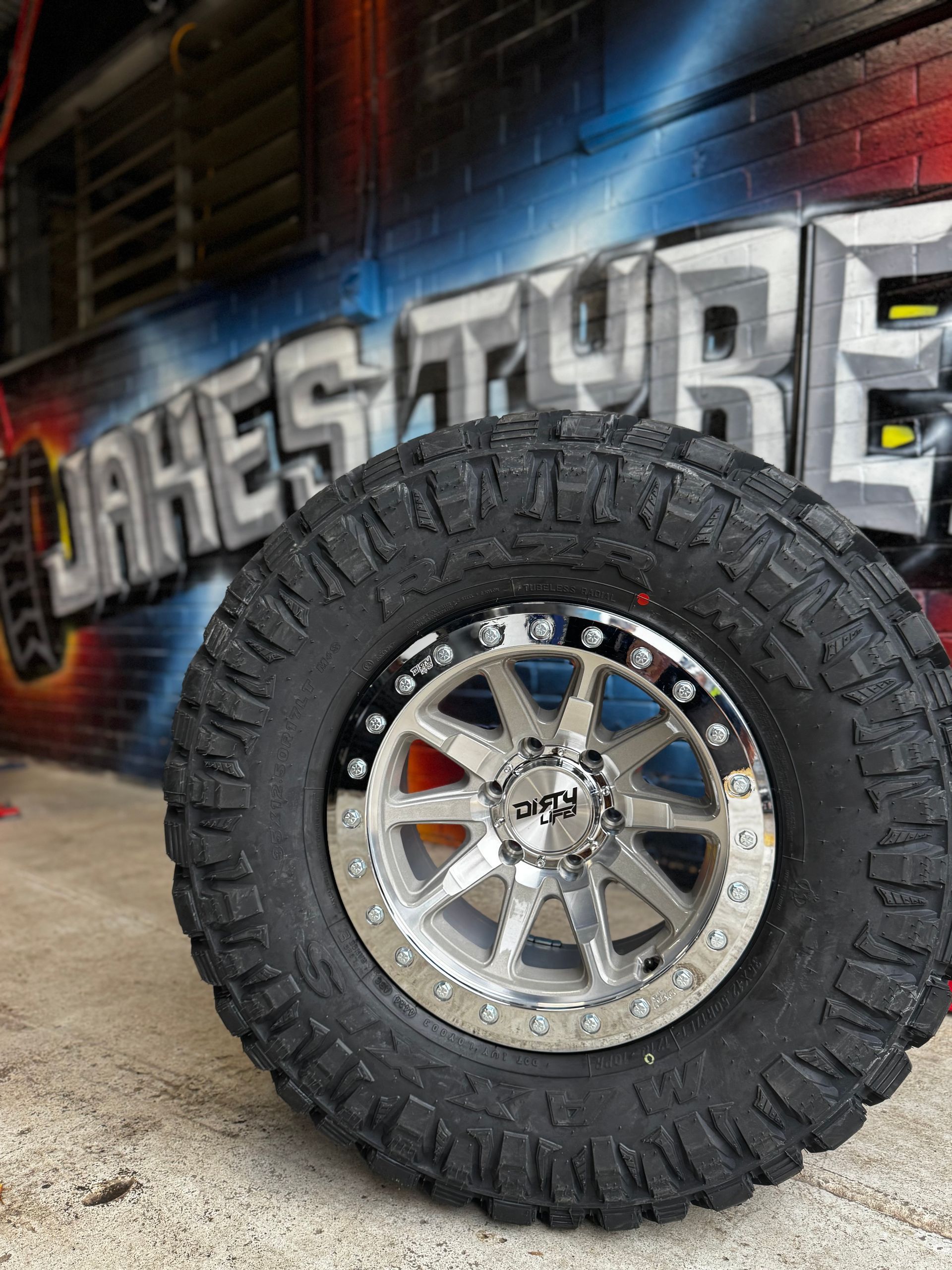 A Close up Of a Large Off Road Tire and Chrome Wheel — Jakes Tyres in South Murwillumbah, NSW