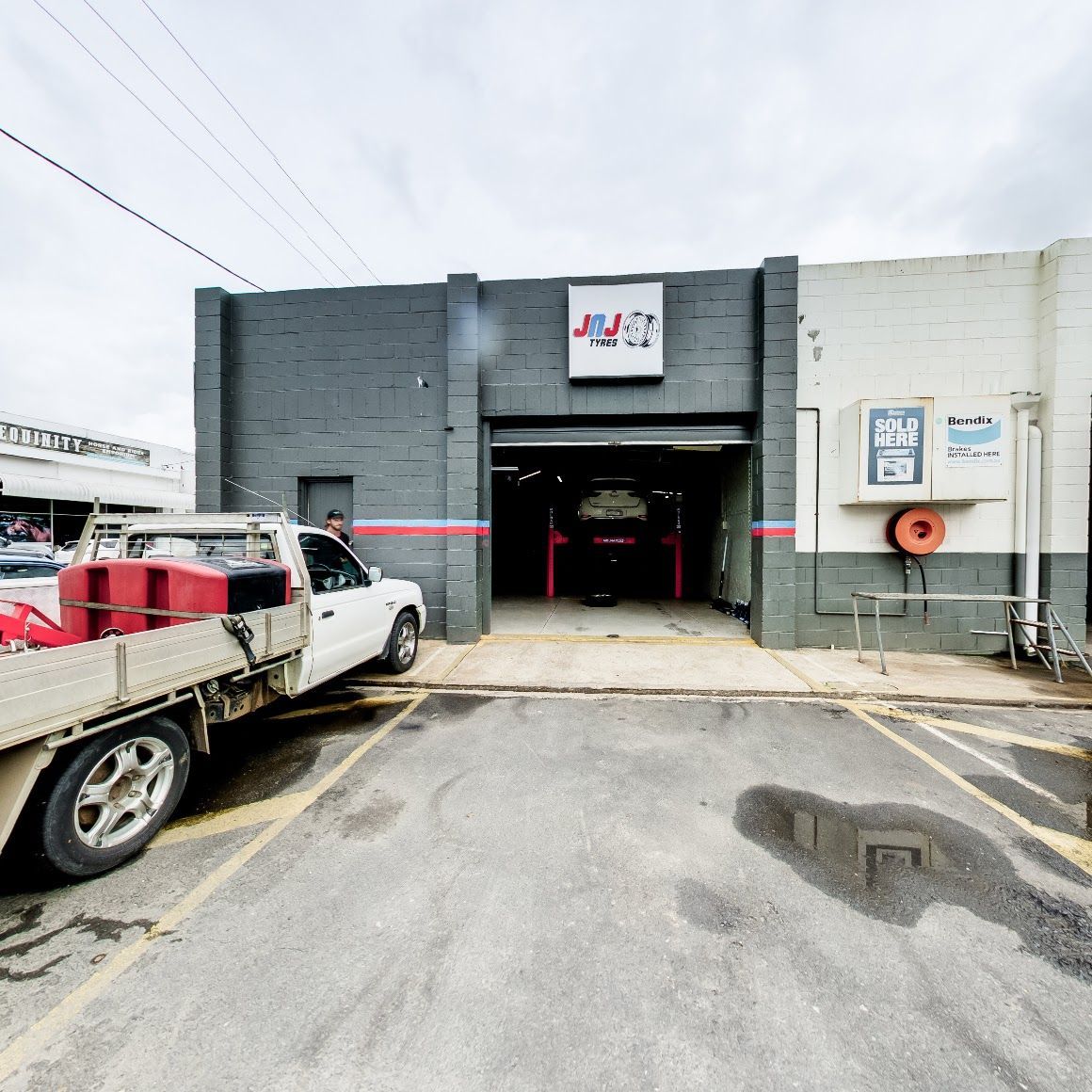 A White Truck Parked in Front of A Car Repair Shop — Jakes Tyres in South Murwillumbah, NSW