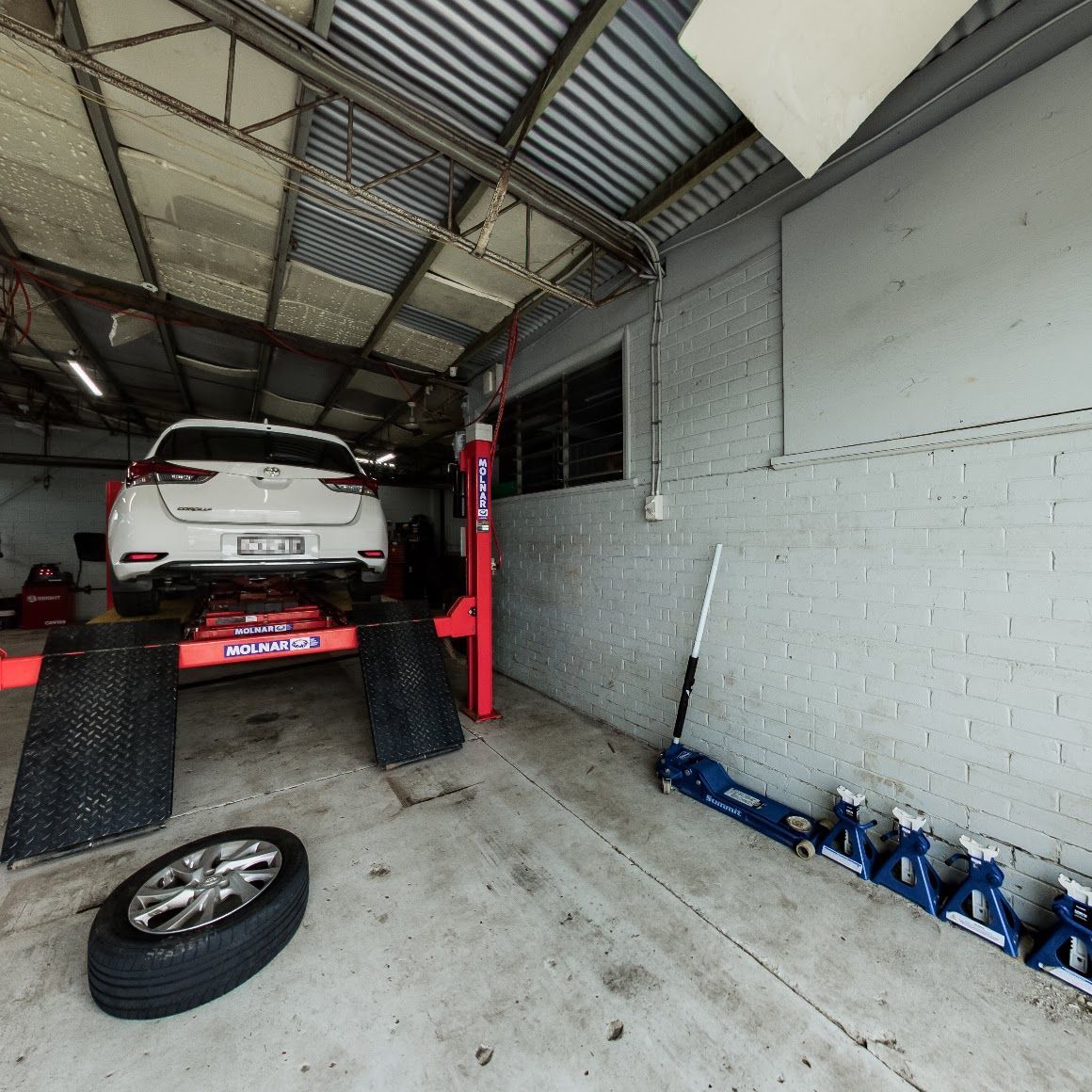 A Car on A Lift in A Repair Shop — Jakes Tyres in South Murwillumbah, NSW