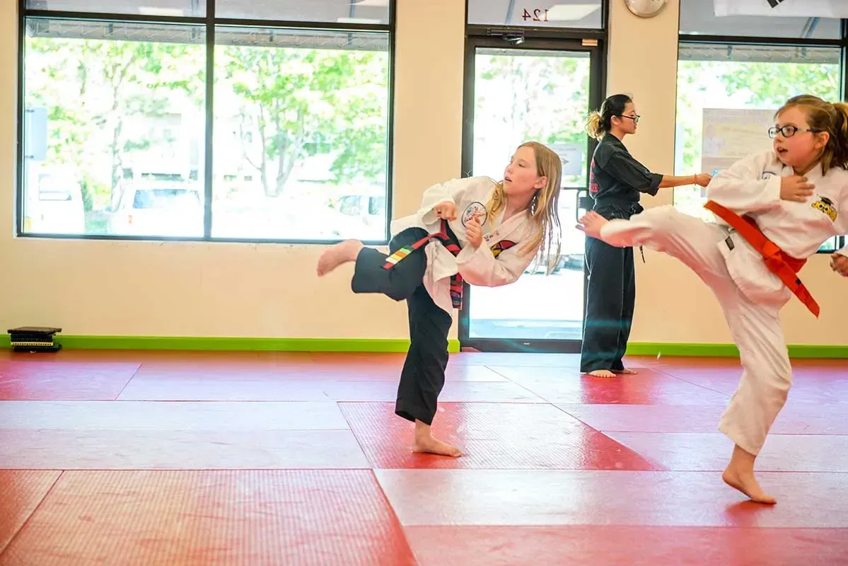 Two children practicing martial arts