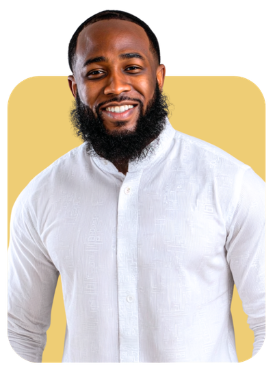Man with a beard smiles, wearing a white shirt against a yellow background.