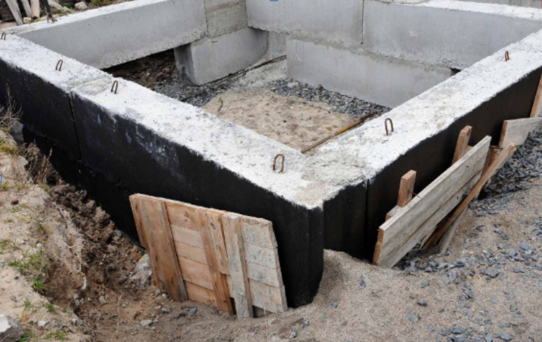 A concrete foundation for a house is being built.