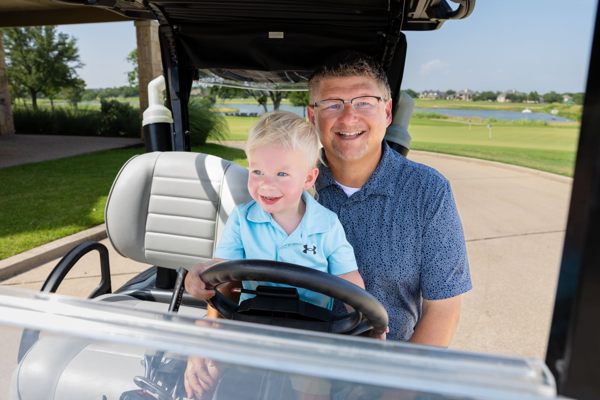 A man and woman are shaking hands with a real estate agent in a living room.