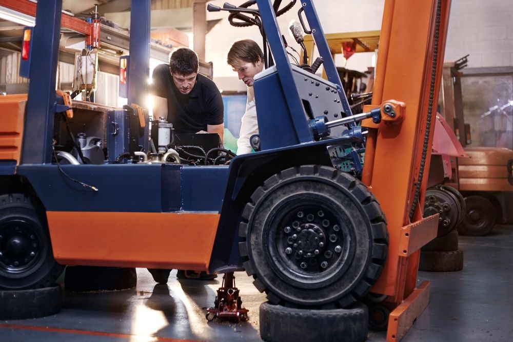 Mechanics Examining And Repairing The Forklift — A1 Forklifts In Coffs Harbour, NSW