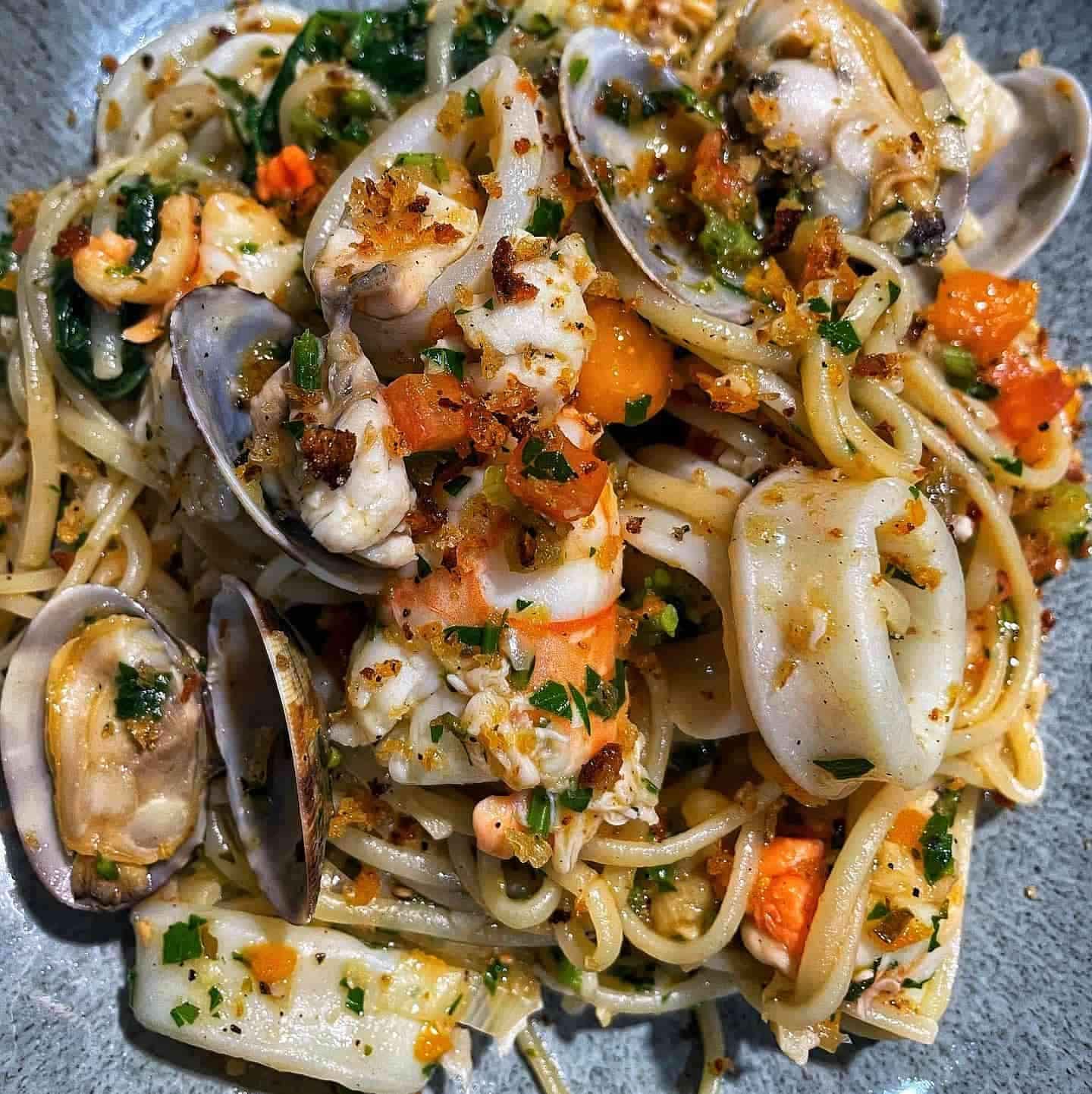 A Close Up of a Plate of Spaghetti With Seafood on a Table — Onesta Cucina in Bowral, NSW