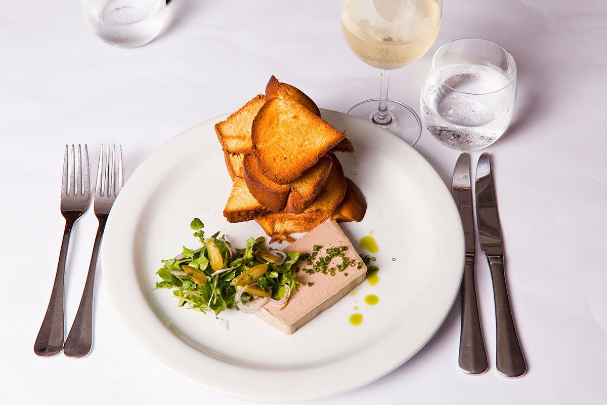 A Plate of Food With Toast and a Glass of Wine on a Table — Onesta Cucina in Bowral, NSW