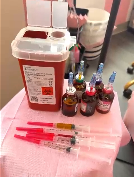 A sharps container and syringes are on a table from urbanrx health lounge in houston, tx