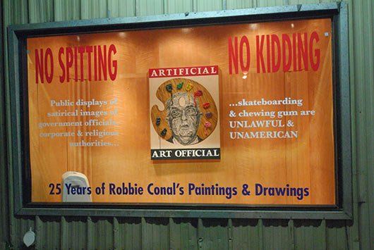 A sign that says no spitting and no kidding