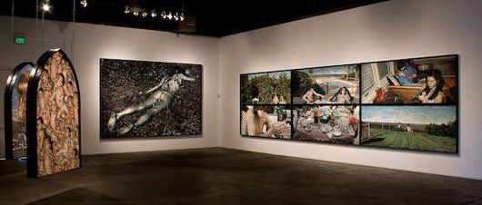 A room with a lot of paintings on the wall.