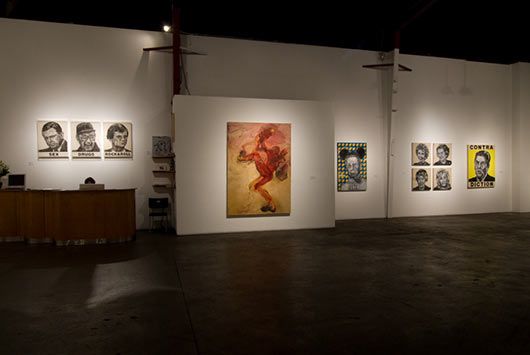 A large room with a lot of paintings on the wall.