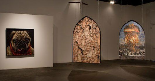 Display of Mondongo art on white walls of an art gallery.