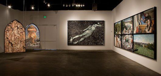 A room with a lot of paintings on the wall