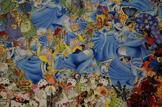 A close up of a collage of disney characters on a table.