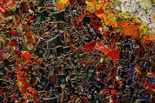 A close up of a colorful painting on a wall.