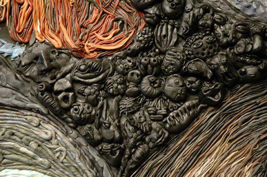 A close up of a sculpture with a lot of different objects on it.