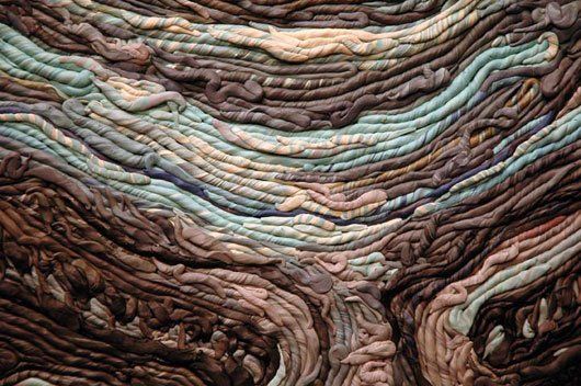 A close up of a piece of yarn that looks like a tree trunk.