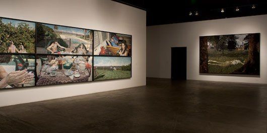 A room with a lot of paintings on the wall.