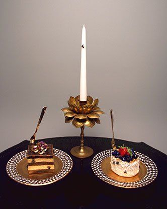 Two plates of cake and a candle on a table