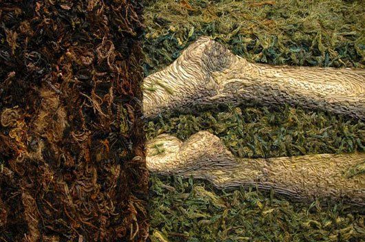 A close up of a pile of tobacco next to a pile of grass.