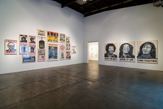 A large room with a lot of paintings on the wall.