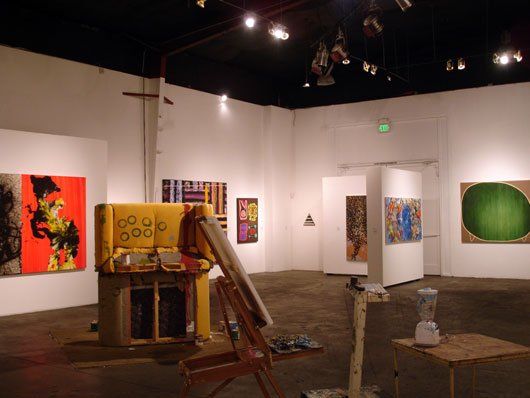 A room with a lot of paintings on the walls