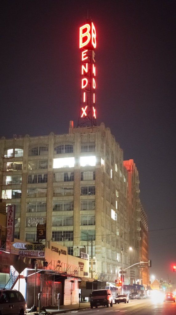 A large building with a neon sign on top of it