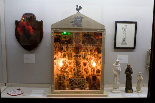 A display case with a chicken on top of it