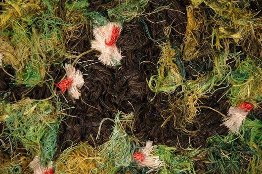 A close up of a pile of yarn with flowers on it.