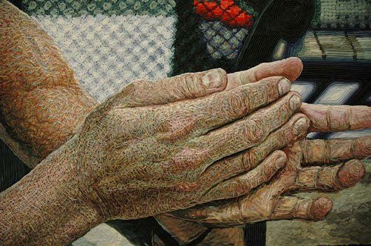 A close up of a person 's hands in a painting.