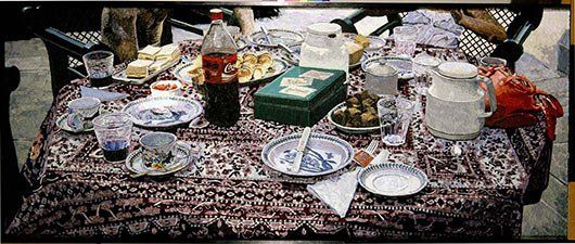 A table with plates , cups , and a bottle of soda on it.