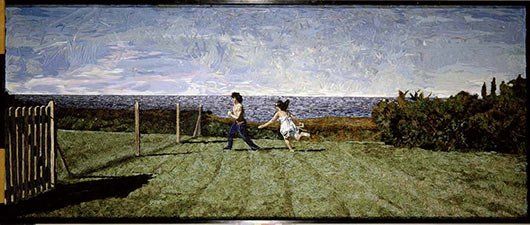 A man and a woman are holding hands in a field.