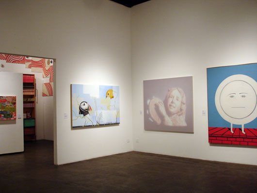 A room with a lot of paintings on the wall