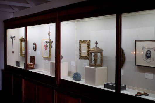 A row of glass display cases filled with various items