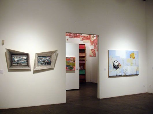 A room with a lot of paintings on the wall