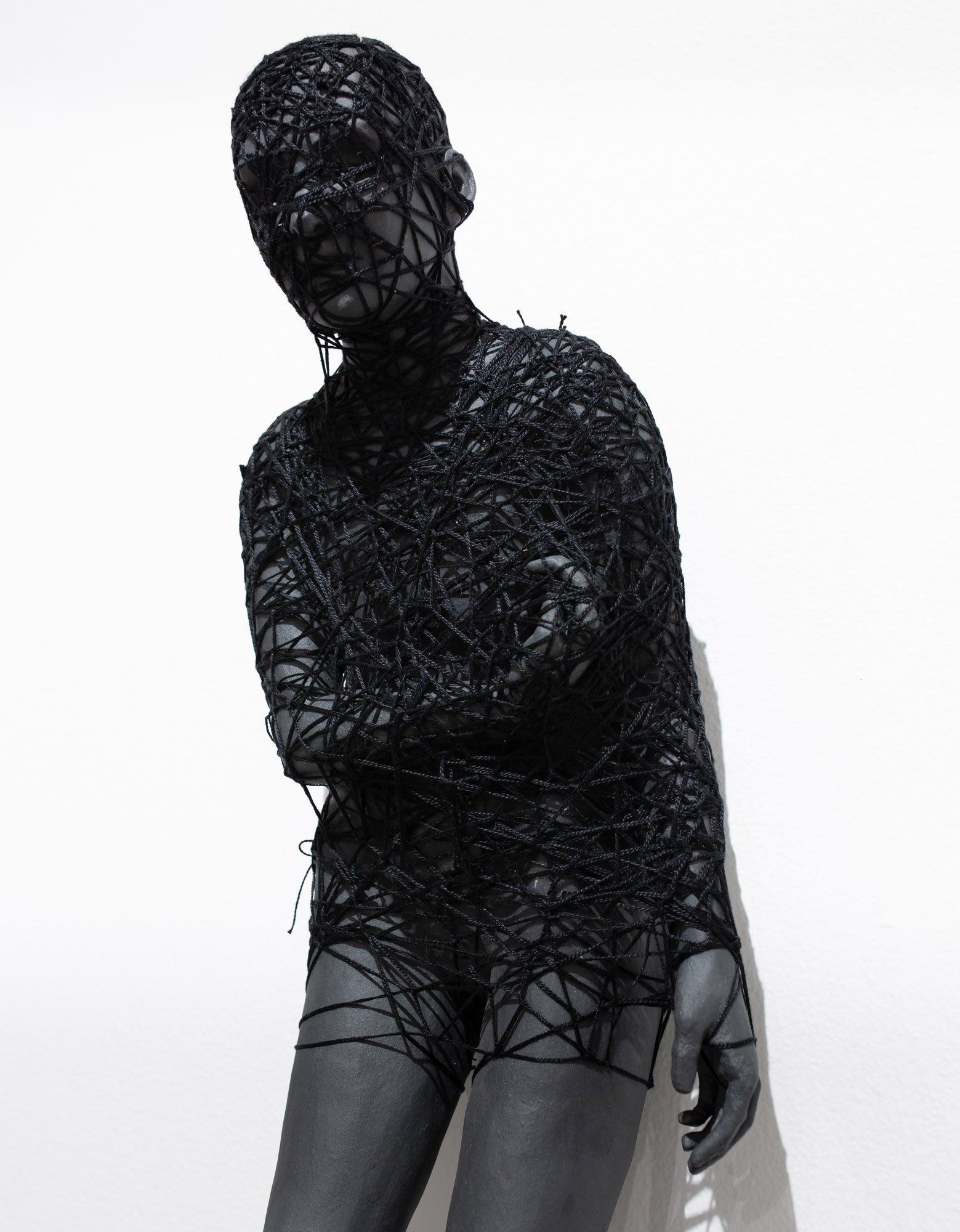 A statue of a person with their arms crossed