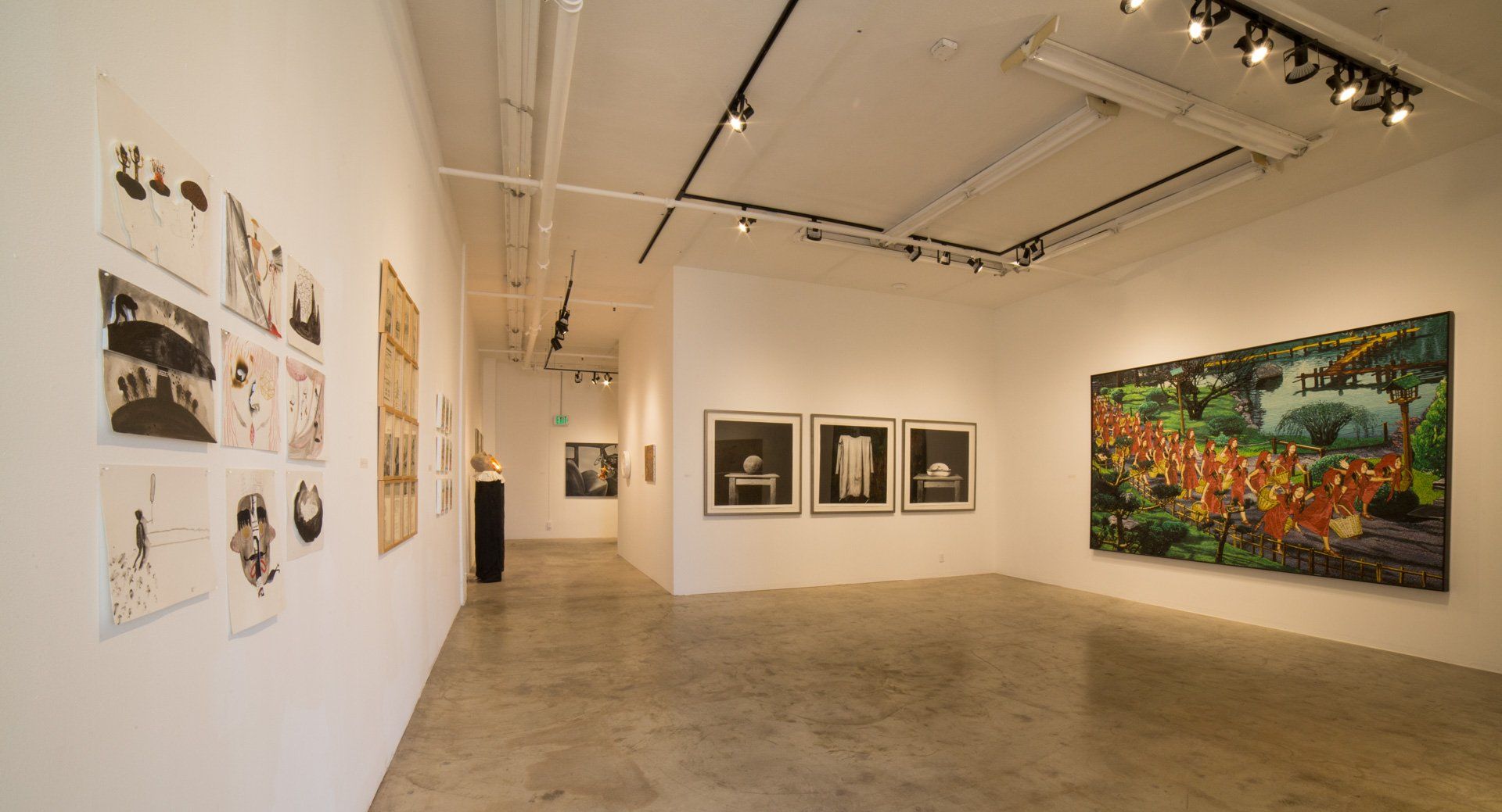 A large empty room with a lot of paintings on the walls