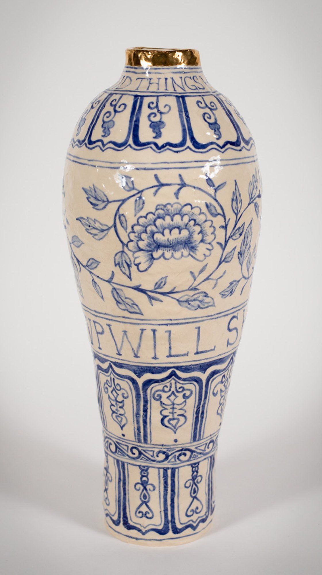 A blue and white vase with the word wills on it