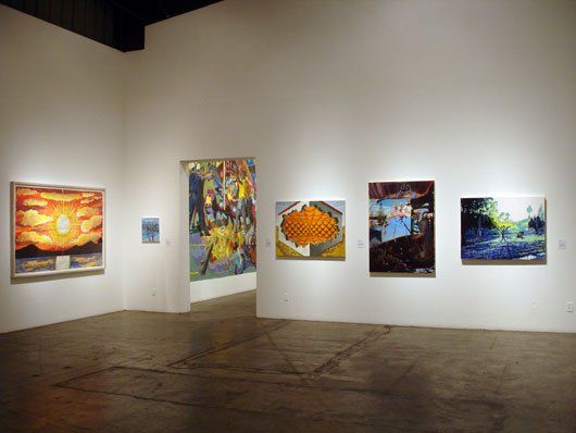 A room with a lot of paintings on the wall