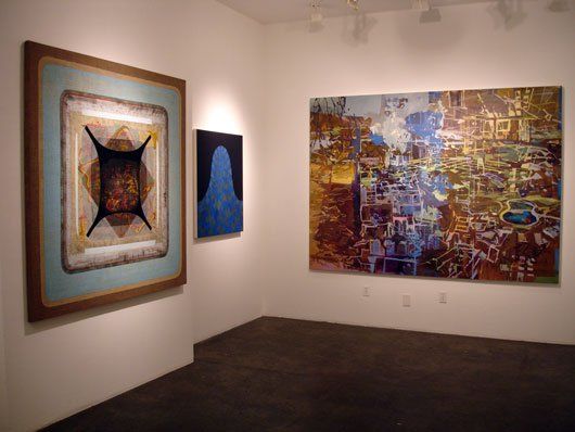 Two paintings are hanging on a wall in a room