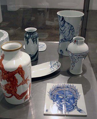 A table with a variety of vases and plates on it