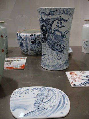 A blue and white vase with a dragon on it is sitting on a table.