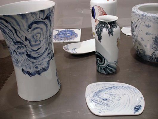 A group of blue and white vases and plates on a table