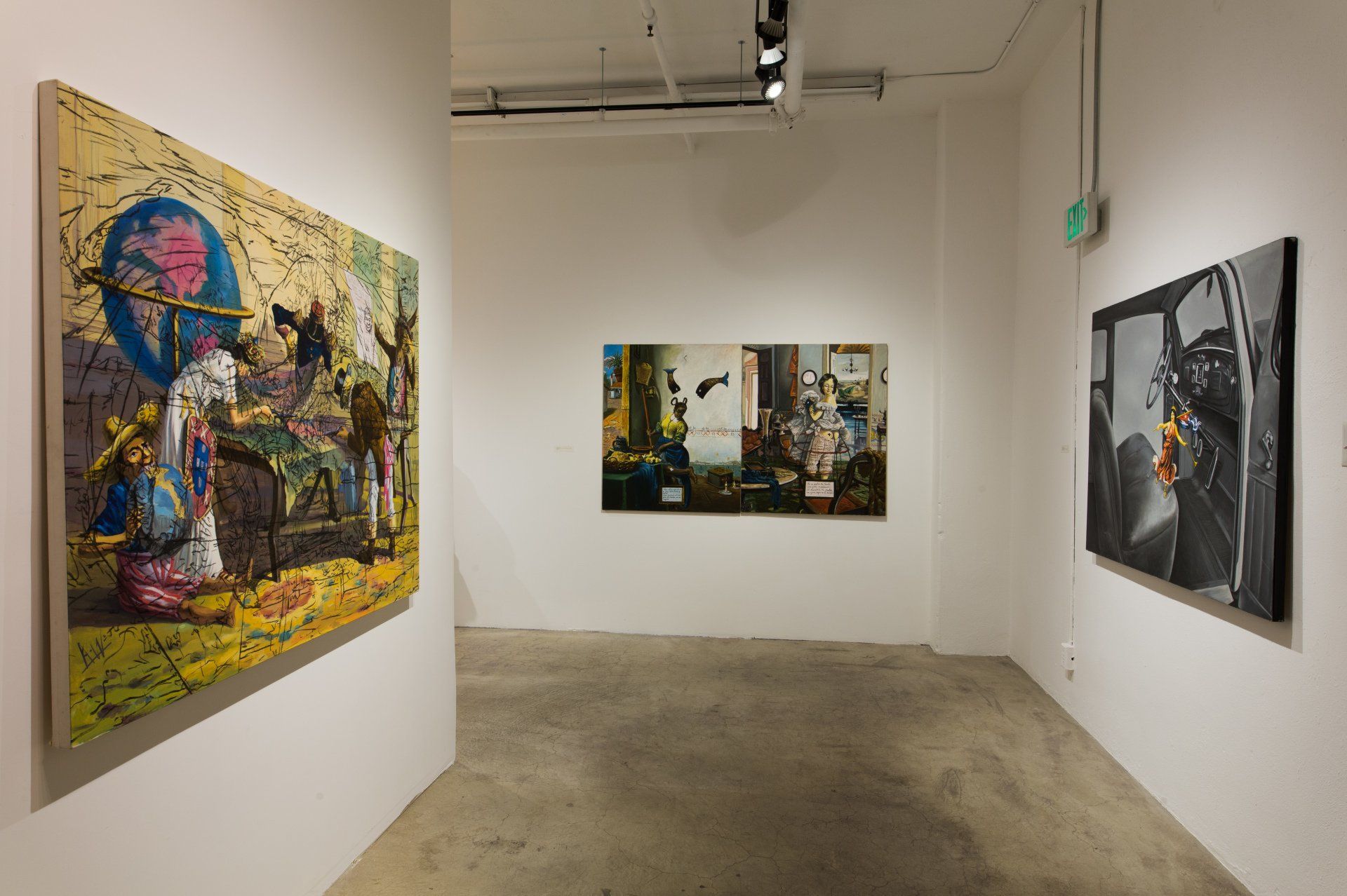 A room with a lot of paintings on the wall