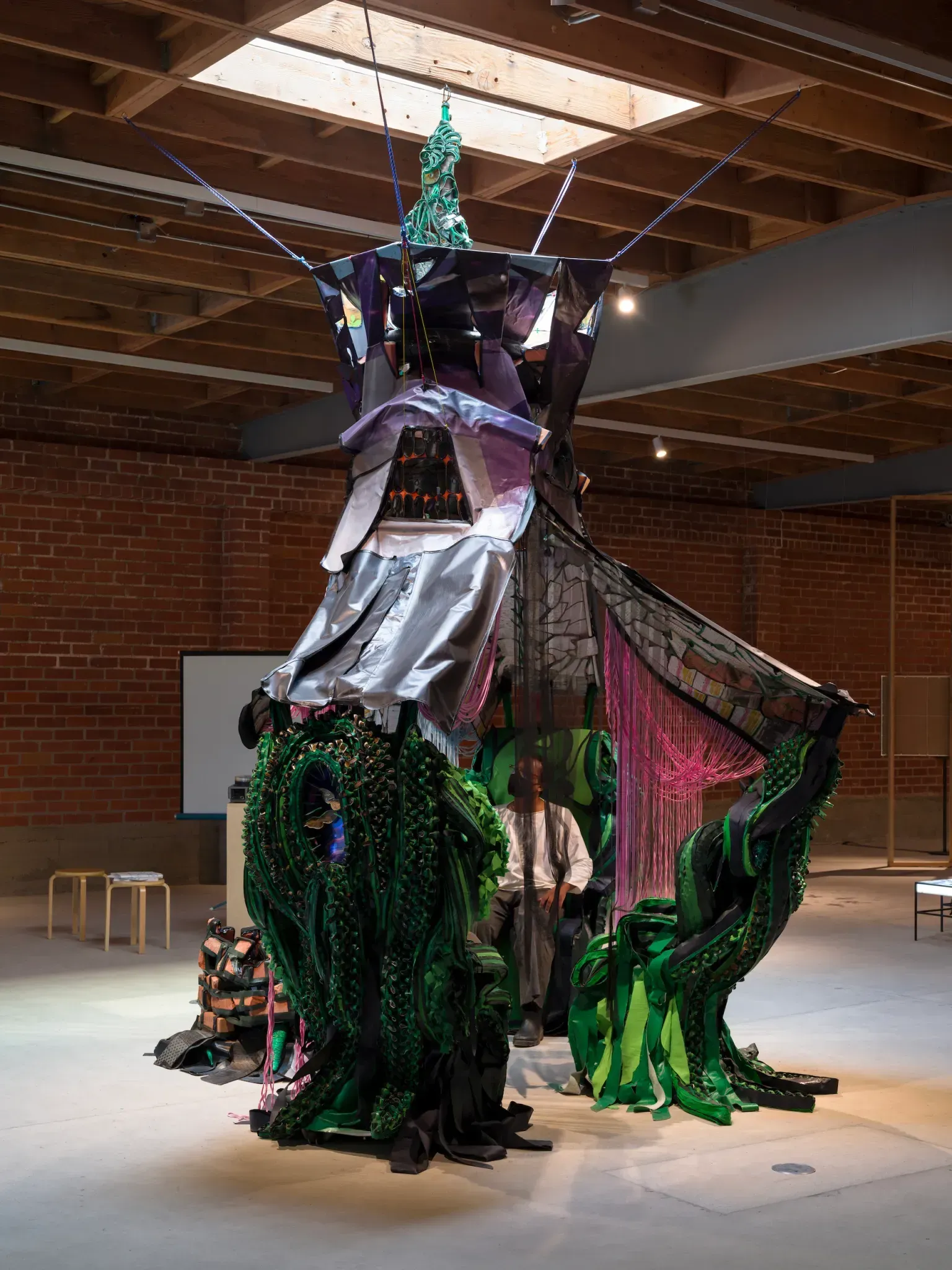 Painting of a woman with five eyes blending with an image of a ballroom.