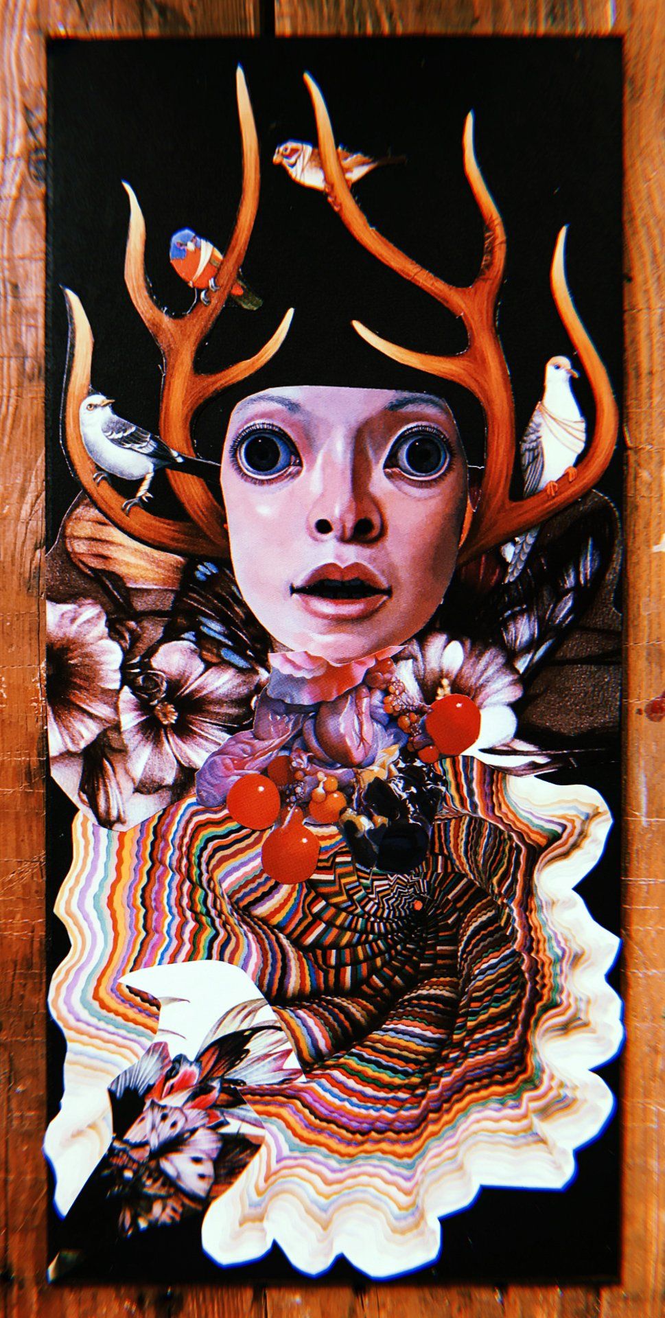 A painting of a woman with antlers and flowers on her head.