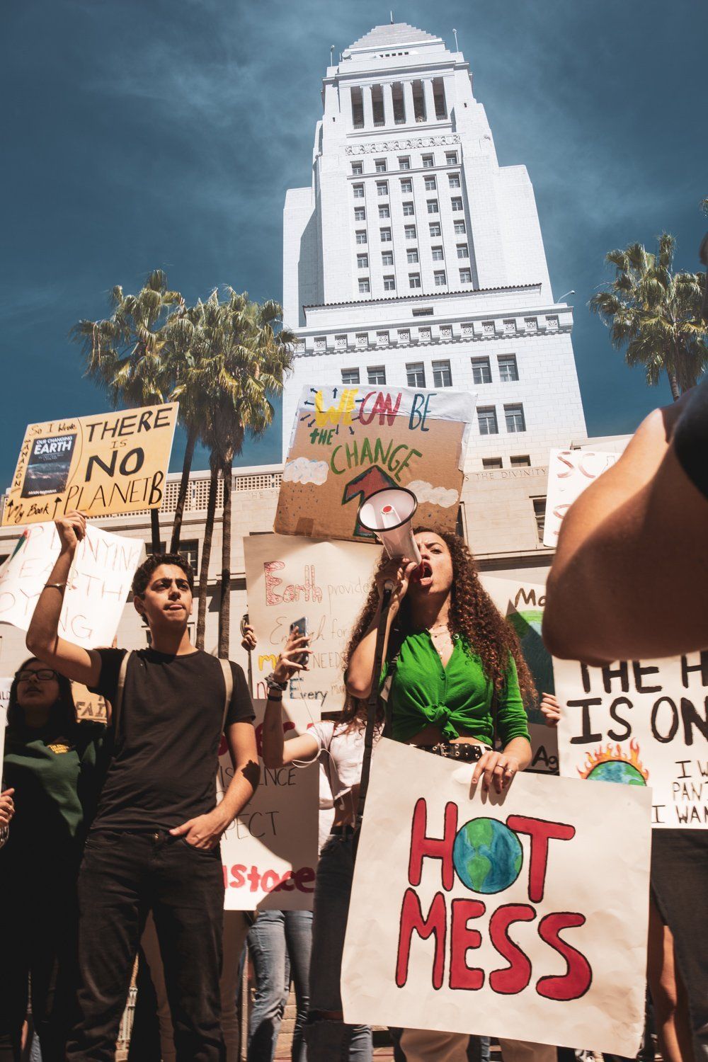 A group of people are holding signs at a protest against climate change.