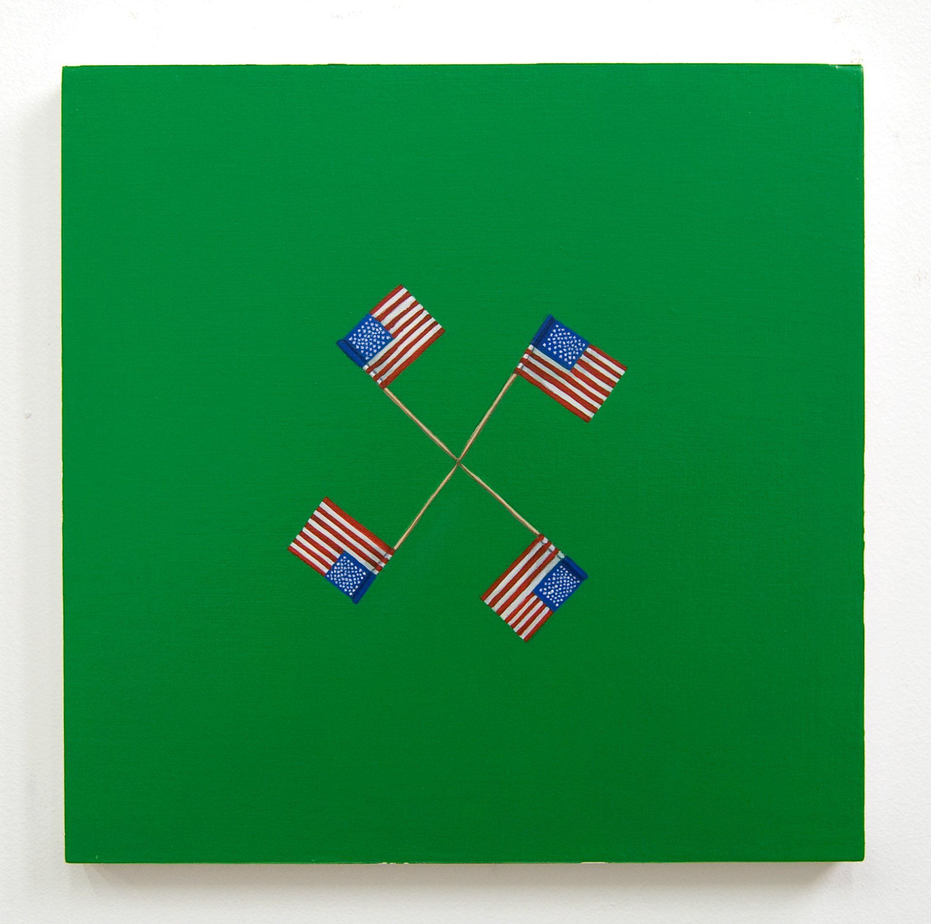 Four american flags are crossed over each other on a green background.