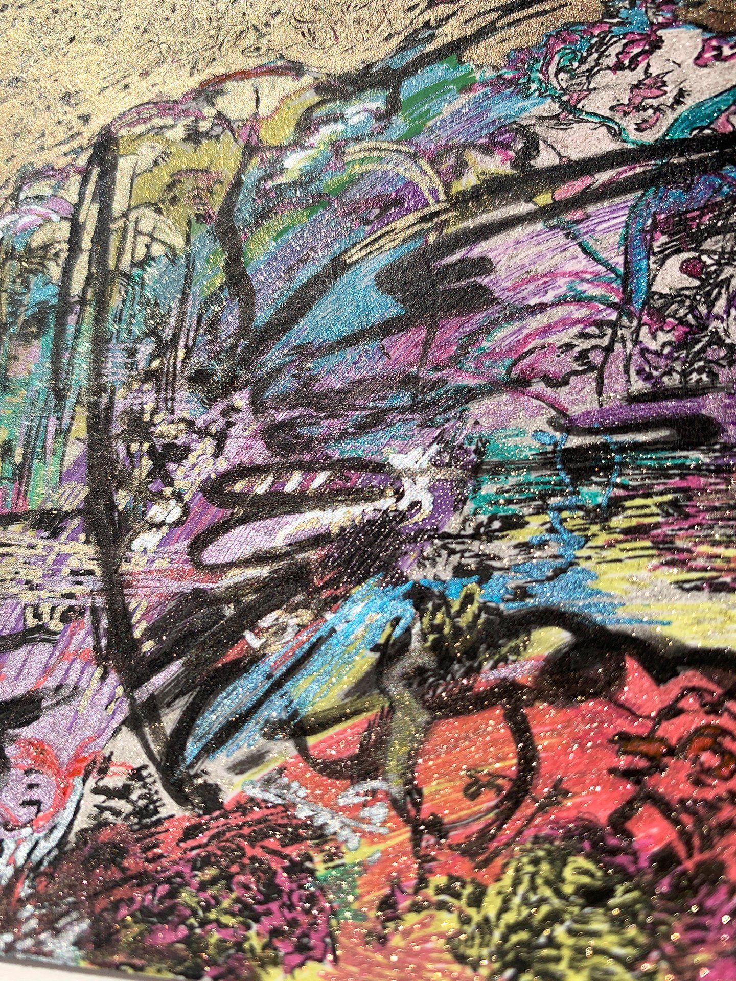 A close up of a colorful painting on a wall.